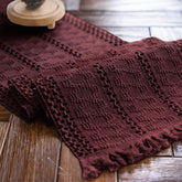 Alynsehom burgundy macrame table runner with tassels enhances boho dining ambiance.