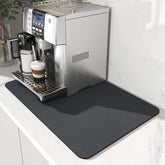 AMOAMI Coffee Mat sits under the coffee maker to keep counters clean and dry.