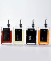 APT 1101 four glass bottles dispenser set on counter for precise pouring.