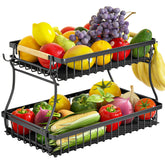 Baecel 2-tier fruit basket with banana hangers on a counter, for easy access to fresh produce.
