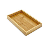 Bam & Boo bamboo serving tray on coffee table, rectangular wood-tone, ideal for drinks and decor.