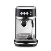 Breville Bambino Plus espresso shot with rich crema in a compact home setup.