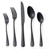 BRIOUT matte black silverware set for four on a dinner table