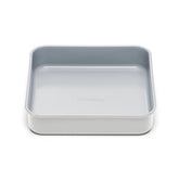 Caraway 9-inch square pan releasing fudgy brownies with the ceramic non-stick coating.