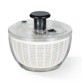 CAROTE 3.8qt salad spinner with transparent bowl for easy viewing and thorough washing.