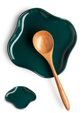 Cormomu spoon holder with ruffled edge in dark green on counter, decorative and functional