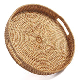 Decrafts round rattan tray with handles for easy serving.