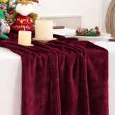 DeZerlor velvet table runner draped on a festive table for elegant holiday dining.