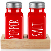 Dopeca red salt and pepper shakers with wood holder on kitchen counter for easy seasoning.