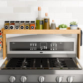 Edgecrest over-stove bamboo shelf with wide storage keeps spices within easy reach.