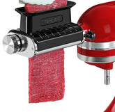 FavorKit meat tenderizer attachment installed on a KitchenAid mixer for even tenderizing.