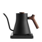 Fellow Stagg EKG Pro Studio Edition front view in matte black with walnut accent for premium brewing