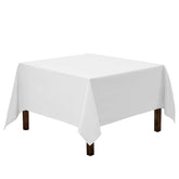 Gee Di Moda square tablecloth spread on a small table for elegant dining