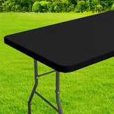 Homing rectangle table cloth cover with elastic edge secures an 8-foot table outdoors.