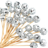Hushee disco ball cocktail picks illuminate appetizers for festive entertaining.