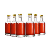 Kaachli clear glass bottle front view for portable 6 oz servings.