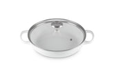 Le Creuset round braiser in enameled iron finish, even heat distribution.