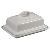 Le Creuset butter dish on counter showing two-stick capacity and white finish.