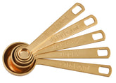 Le Creuset gold measuring spoons with 1-8-tsp precision for baking.