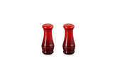 Le Creuset salt and pepper shakers in Cerise on a table for everyday seasoning