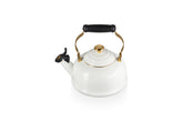 Le Creuset white enamel whistling kettle with gold knob for quick boiling