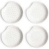 LE TAUCI spoon rest with embossed flower design sits on the stovetop to catch drips