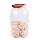 Leaves and Trees Y large glass canister with airtight wooden lid for pantry organization.
