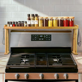 MAVOTER over-the-stove shelf keeps spices within easy reach behind the stove.