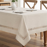 MIULEE beige rectangle tablecloth with decorative cutouts enhances centerpieces for gatherings at home.