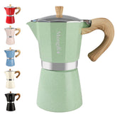 Mongdio green stovetop espresso maker viewed from the front, signaling rich aroma and home brewing.