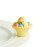 Nora Fleming A Tisket, A Tasket eggs basket mini on spring display adds seasonal charm.