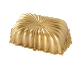 Nordic Ware Classic Fluted Loaf Pan side-angle view in gold highlighting detailed texture