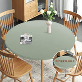 Obstal sage green fitted round tablecloth showing elastic edge on a round table.