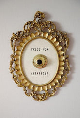 Okuorze Press for Champagne Button in metal frame adds hotel-inspired decor.