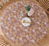 Pioggia round vinyl fitted tablecloth with elastic edge securing a 37-44 inch round table for meals