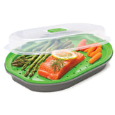 PrepSolutions steamer basket for fish and veggies in use; non-stick surface cleans easily.