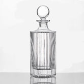 Queenstone whiskey decanter round ribbed design enhances table presentation.