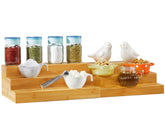 RoyalHouse Bamboo expandable spice rack with 3 tiers organizes spices in a tidy cabinet.