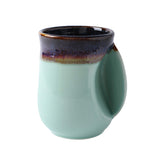 Selamica porcelain mug with ergonomic pocket keeps hands warm during tea.