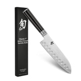 Shun Classic 7-inch hollow-ground santoku blade for smooth vegetable and protein slicing.