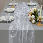 Snowkingdom silver cheesecloth table runner with glittering foil for an elegant wedding backdrop.