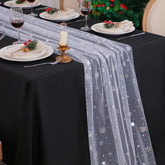 Snowkingdom silver snowflake table runner on full table for festive dining.