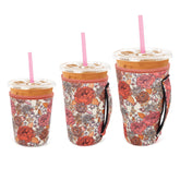 Snowso Flower Power 16oz iced coffee sleeve fits cups securely and reduces spills.