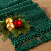 Socomi emerald green boho table runner with macrame fringe enhances rustic dining ambiance.