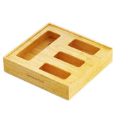 SpaceAid bamboo bag organizer in a drawer with four slots for neat bag storage.