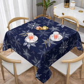 Sphragiyn winter tablecloth with blue snowflakes, ideal for festive dining and easy cleanup.