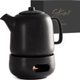 Steinzeit Design Tea Pot with Warmer—sleek black ceramic exterior for heat retention.
