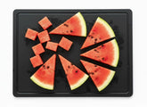 Thirteen Chefs black cutting board with juice groove for tidy meat prep.