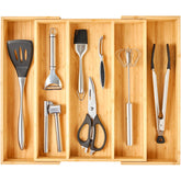 Umilife expandable bamboo drawer organizer with three compartments keeps utensils neatly stored.