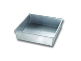 USA Pan 9-inch square pan with corrugated surface for even browning and easy release.